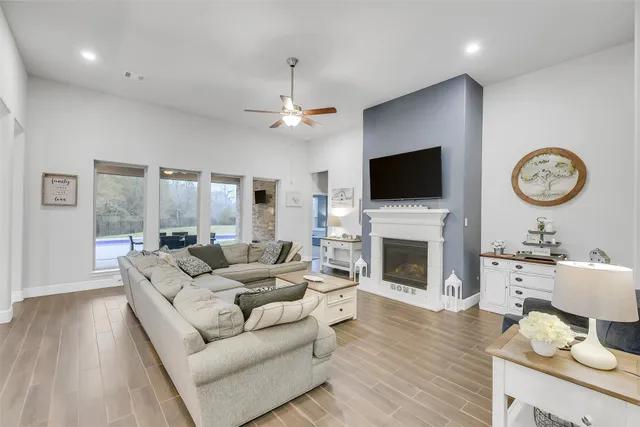 a living room with furniture a fireplace and a flat screen tv