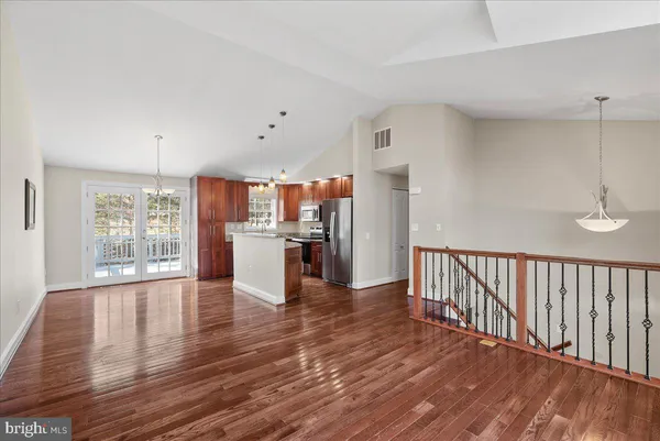 a view of a kitchen with wooden floor