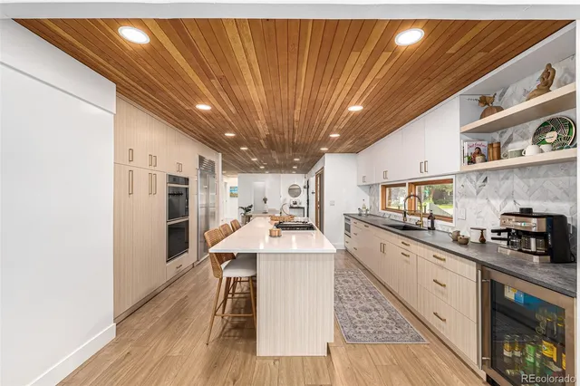 a kitchen with stainless steel appliances granite countertop a sink stove and cabinets
