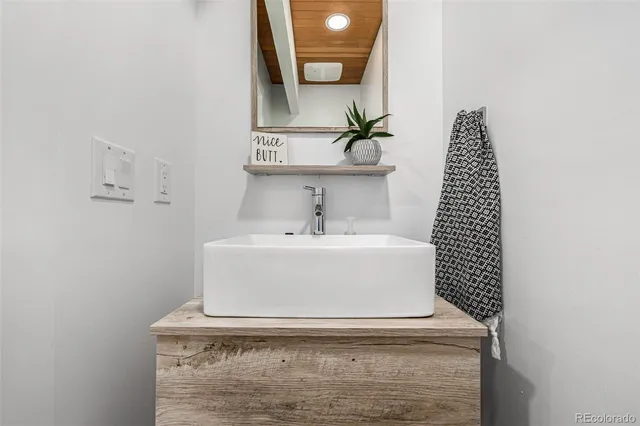 a bathroom with a sink and mirror