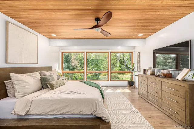 a bed room with a bed and a large window