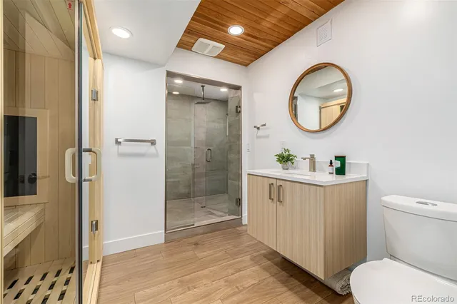 a bathroom with a toilet a sink and a mirror