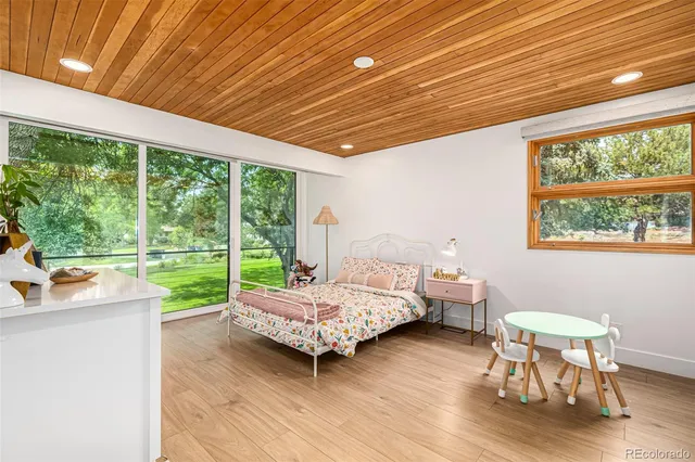 a bed room with a bed and a large window