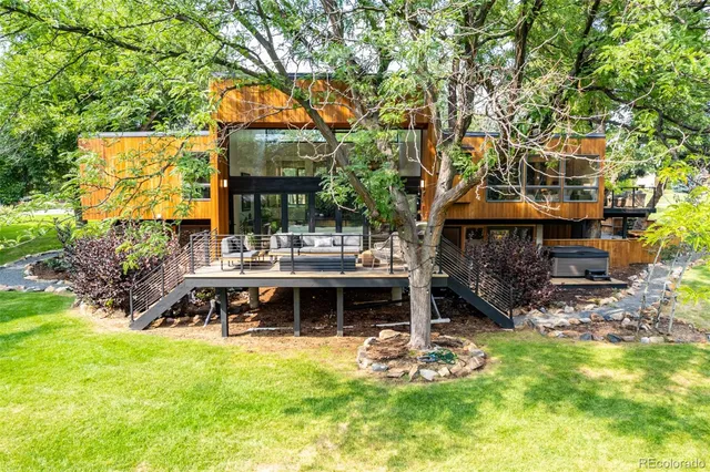 a view of a house with backyard porch and sitting area
