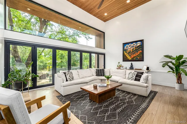 a living room with patio furniture and a large window
