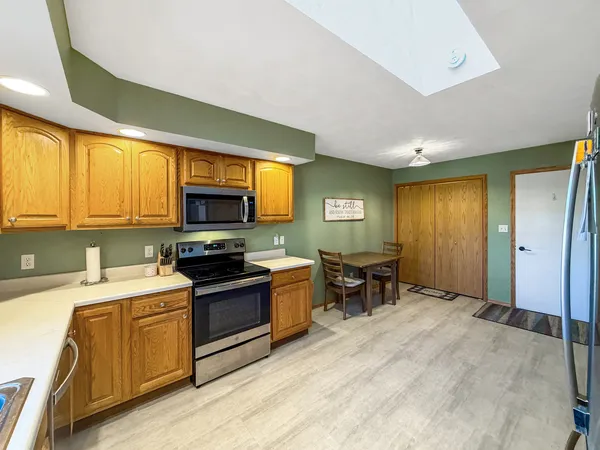 a kitchen with a stove a sink and a microwave