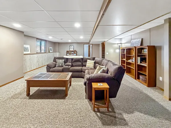 a living room with furniture a ceiling fan and a rug