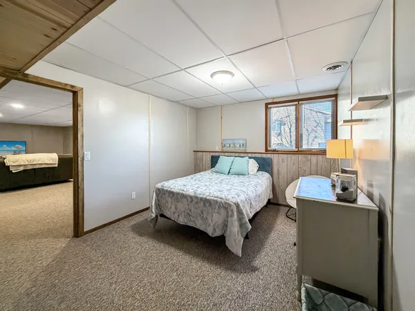 a bedroom with a bed and a chandelier