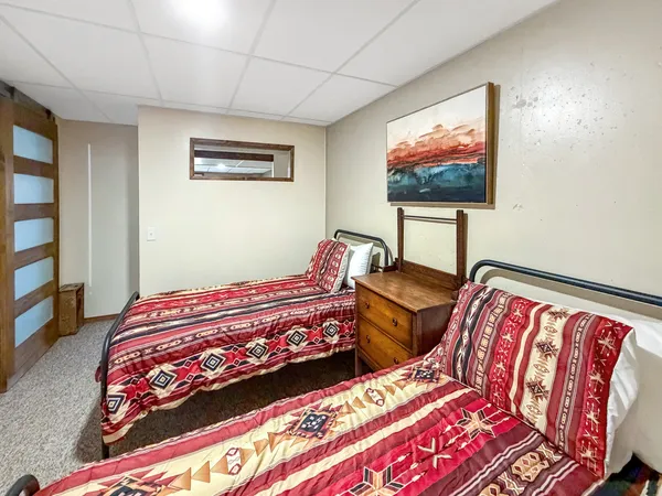 a bedroom with two beds and a flat screen tv