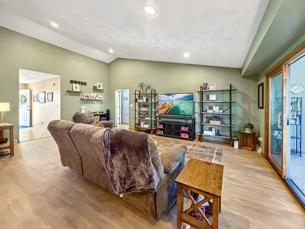 a living room with furniture a couch and wooden floor
