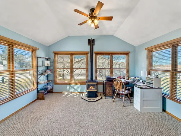 a living room with furniture and large windows