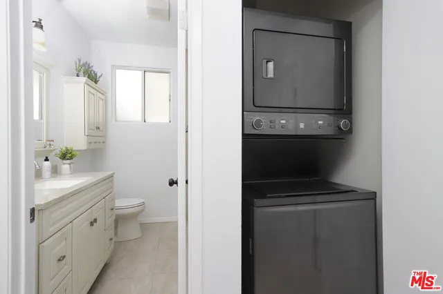 a bathroom with a toilet a sink and a mirror