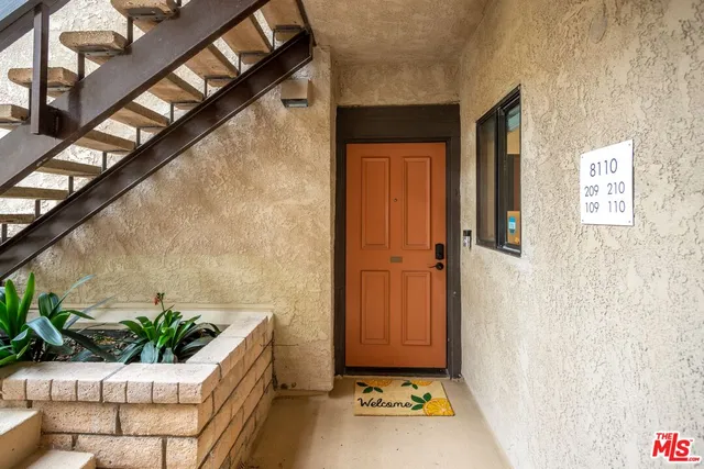 a living room with furniture and potted plant