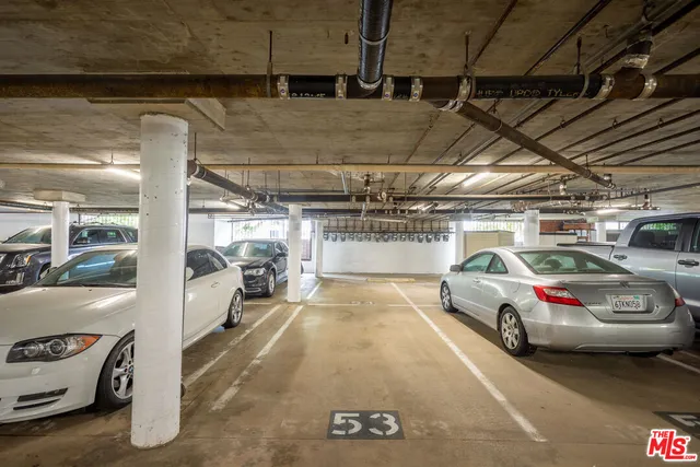 a view of parking garage with cars parked