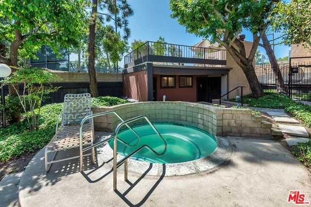 a view of a chairs and table in the backyard