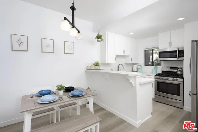 a kitchen with stainless steel appliances kitchen island granite countertop a sink and cabinets