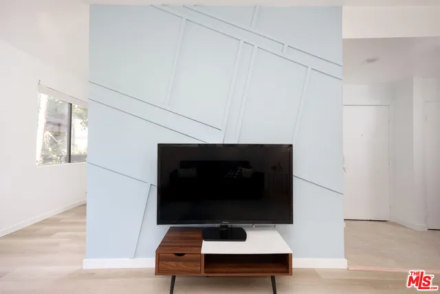 a living room with a lamp and a rug