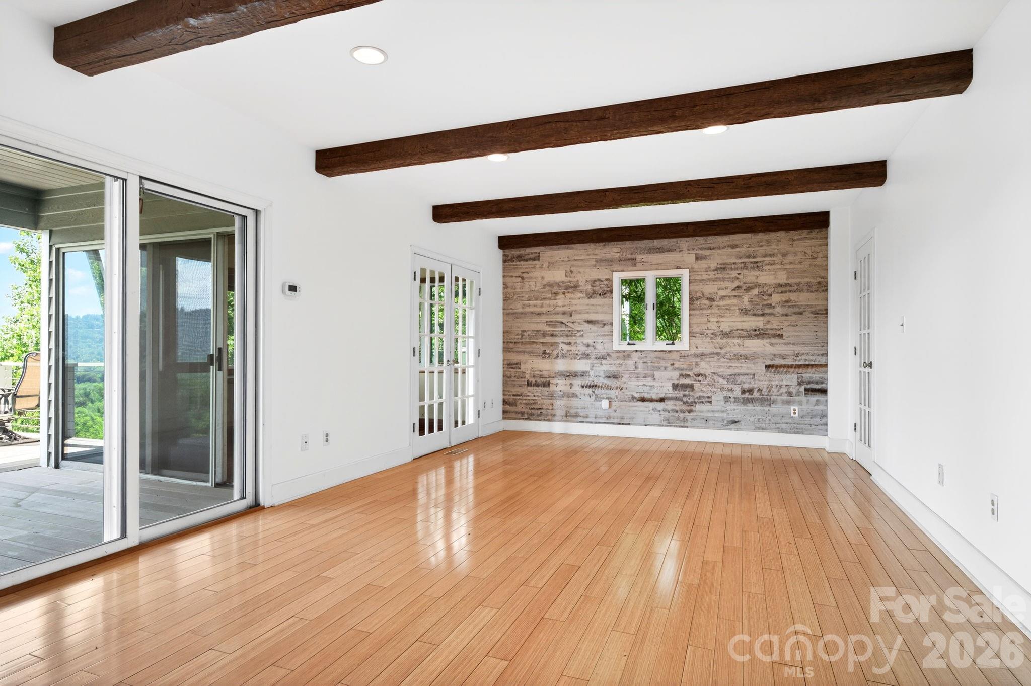 38 Lookout Road Asheville, NC 28804 - Photo 23 of 34 a view of an empty room with wooden floor and a window
