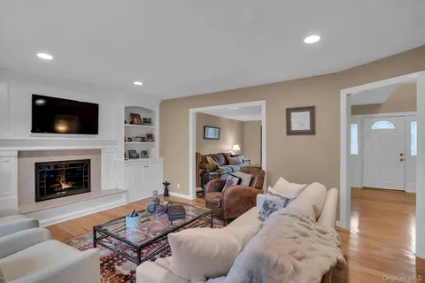 a living room with furniture a fireplace and a flat screen tv