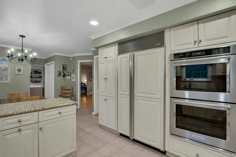 a kitchen with cabinets stainless steel appliances and a counter space