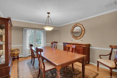 a view of a dining room with furniture and a chandelier
