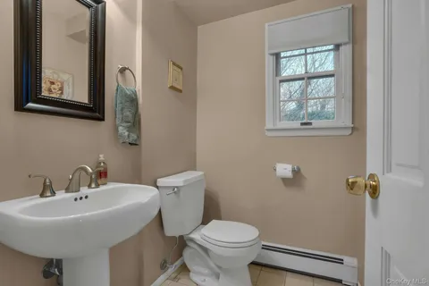 a bathroom with a sink toilet and a mirror