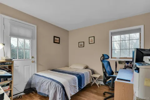 a bedroom with a bed and a desk