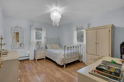 a spacious bedroom with a bed and a chandelier
