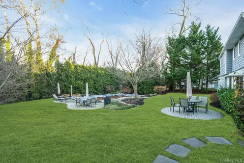 a view of a chair and table in the garden
