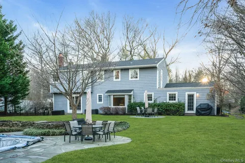a front view of house with yard and outdoor seating