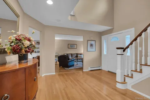 a dining room with furniture and wooden floor