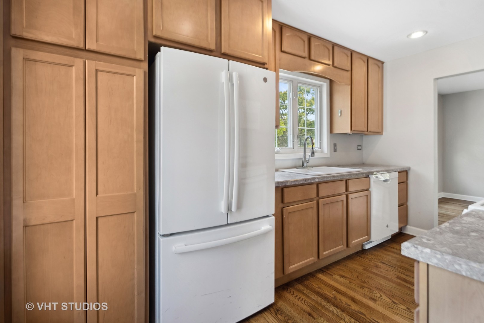 655 Thomas Street Elmhurst, IL 60126 - Photo 12 of 17 a kitchen with stainless steel appliances white cabinets and a refrigerator