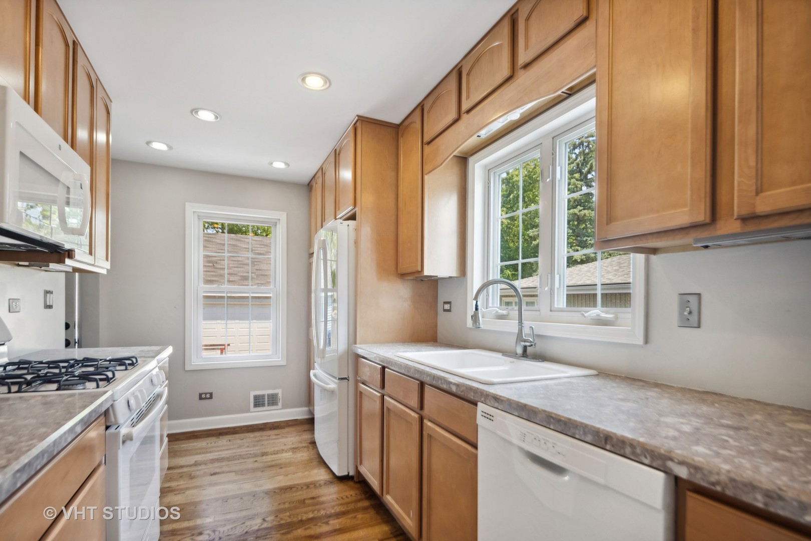 655 Thomas Street Elmhurst, IL 60126 - Photo 13 of 17 a kitchen with stainless steel appliances granite countertop a sink stove and cabinets