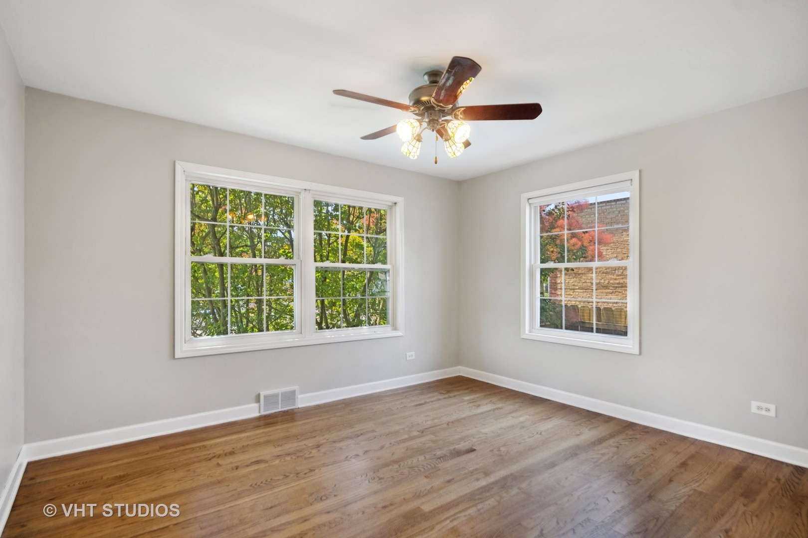 655 Thomas Street Elmhurst, IL 60126 - Photo 16 of 17 an empty room with wooden floor fan and windows