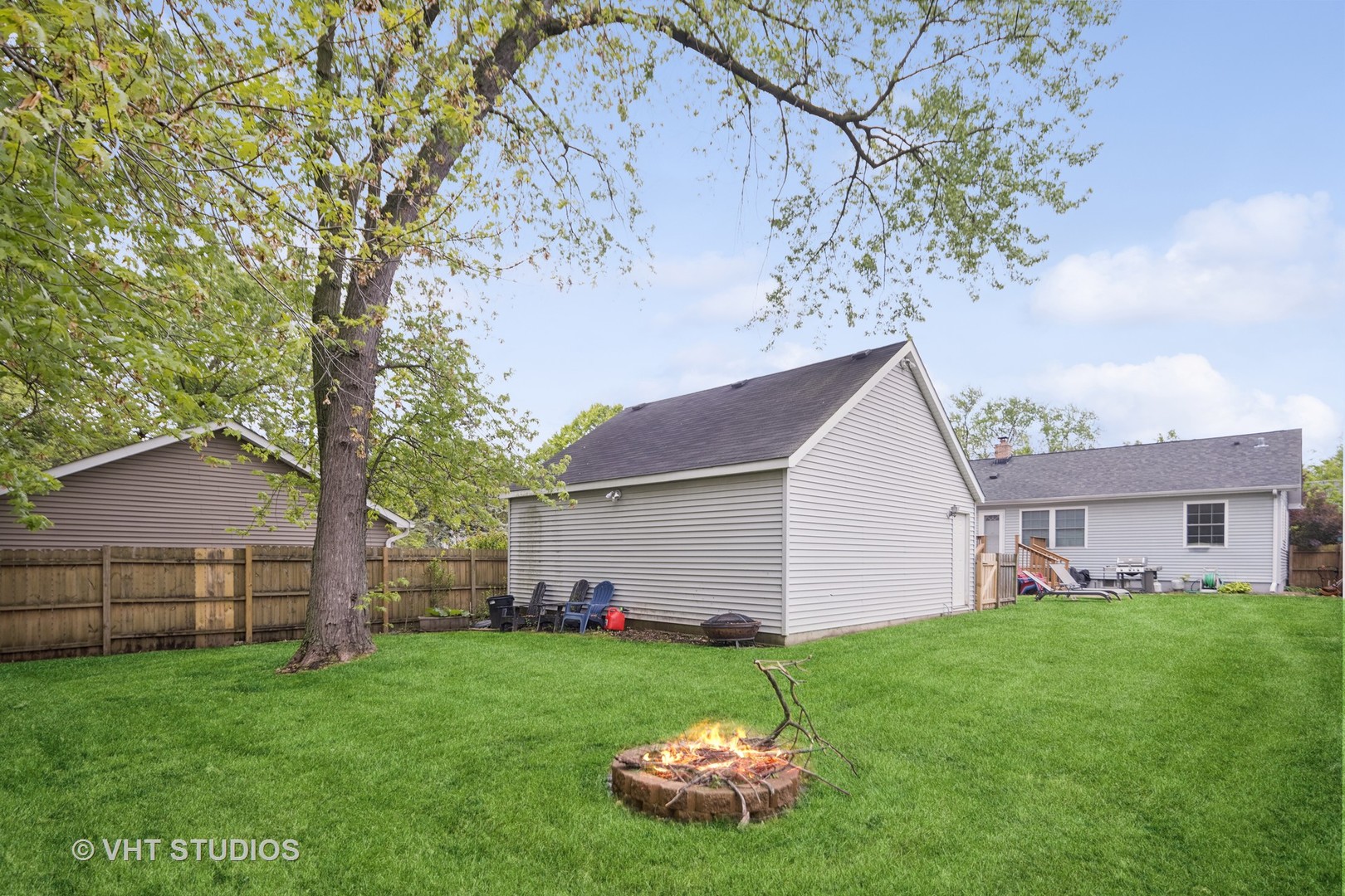 655 Thomas Street Elmhurst, IL 60126 - Photo 3 of 17 a backyard of a house with plants and large tree