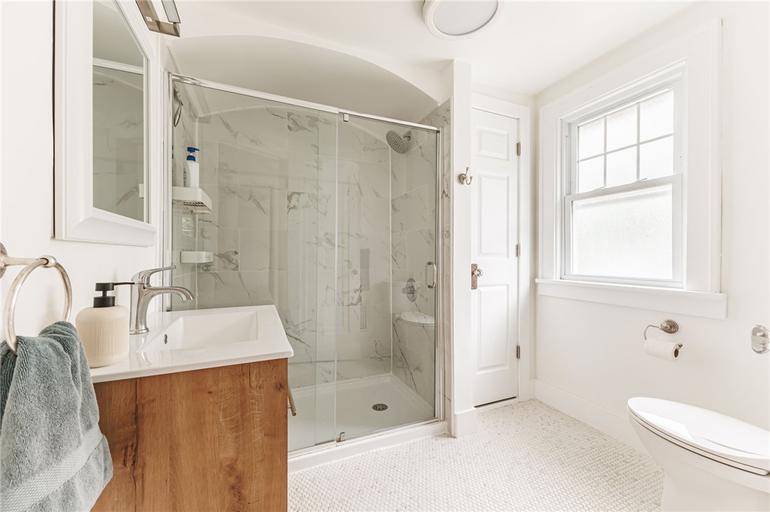55 Elm Drive Rochester, NY 14609 - Photo 22 of 31 Completely remodeled Full Bath with walk-in tiled shower, penny tile floor, new vanity & fixtures