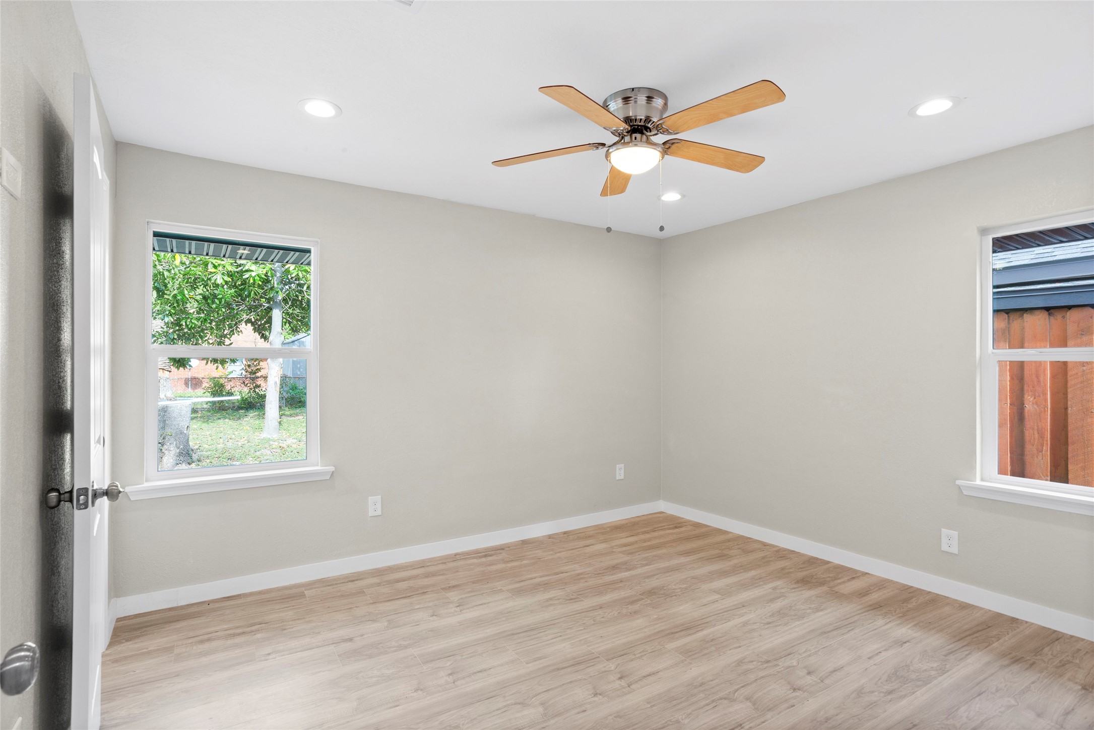 10127 Tolman Street Houston, TX 77034 - Photo 12 of 27 The room features wide-plank, wood-look flooring in a light sand or oak finish that provides a warm, natural feel.Additional lighting is provided by a recessed LED "can" light visible in the ceiling.
