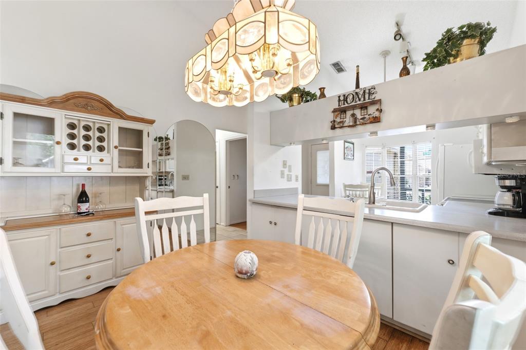 4544 Slippery Rock Road New Port Richey, FL 34653 - Photo 12 of 32 a kitchen with a cabinets and chandelier