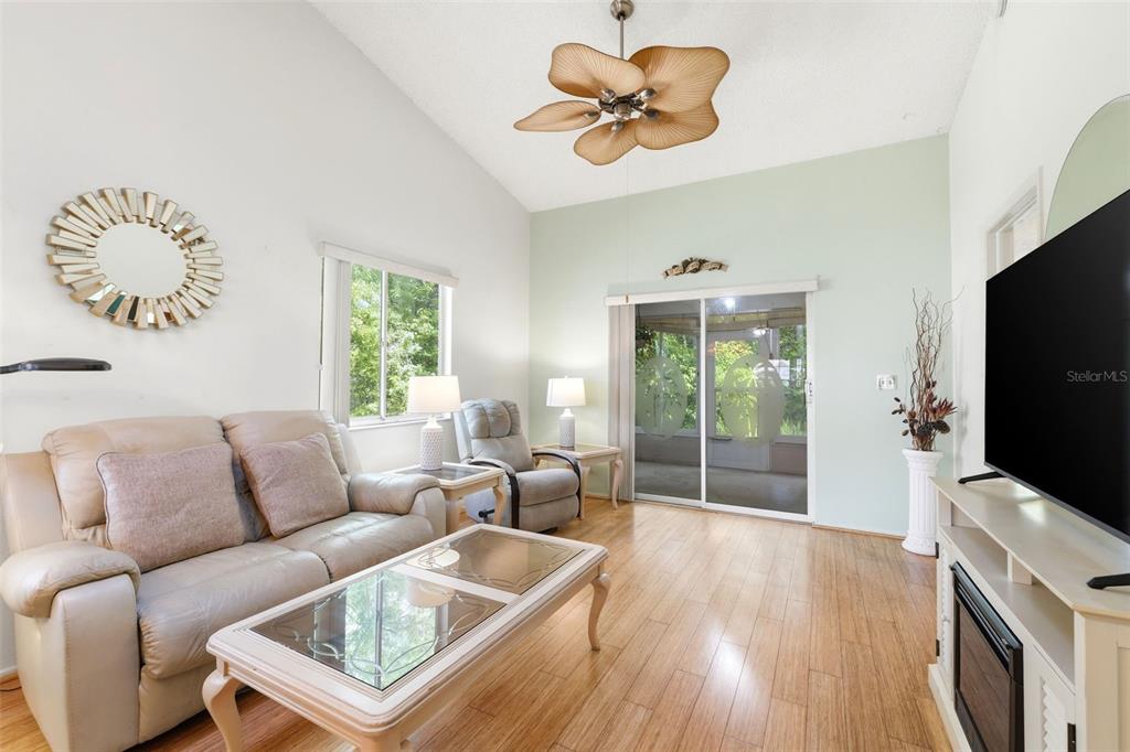4544 Slippery Rock Road New Port Richey, FL 34653 - Photo 13 of 32 a living room with furniture a flat screen tv and a window