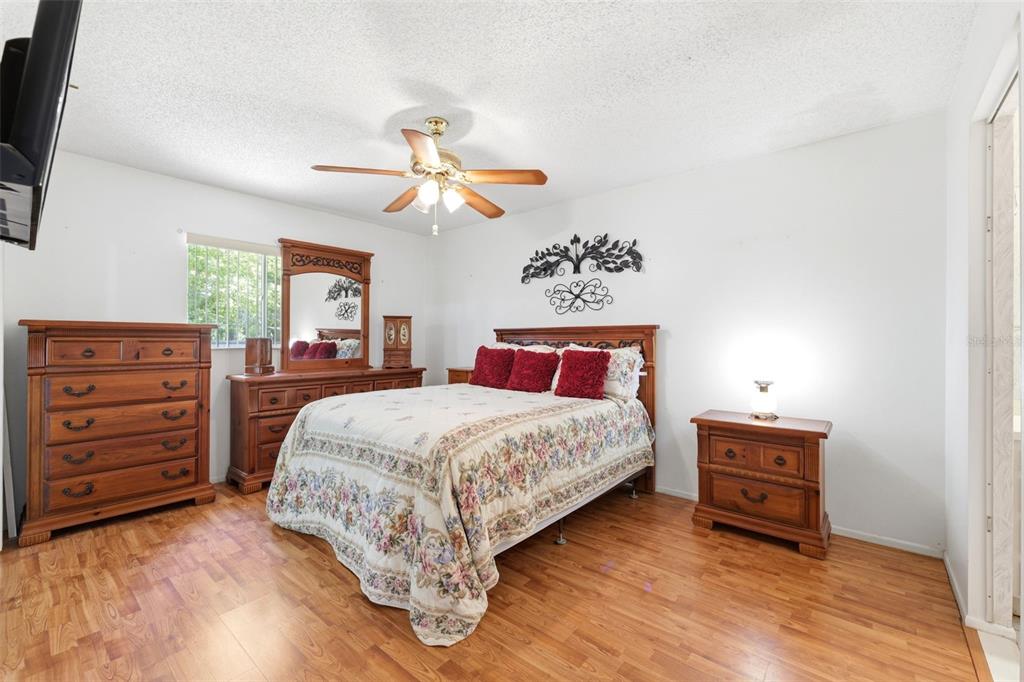 4544 Slippery Rock Road New Port Richey, FL 34653 - Photo 16 of 32 a bedroom with a bed and a dresser