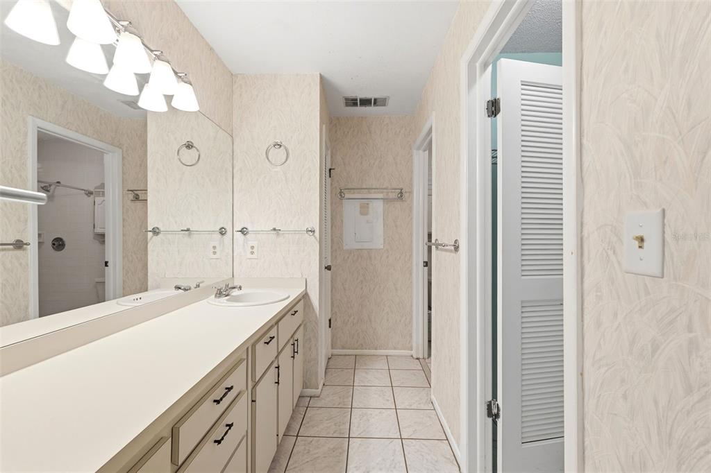 4544 Slippery Rock Road New Port Richey, FL 34653 - Photo 19 of 32 a spacious bathroom with a double vanity sink a mirror and a shower
