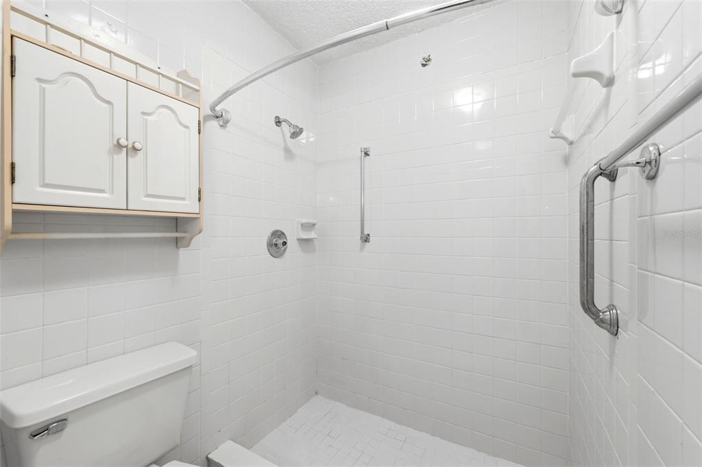 4544 Slippery Rock Road New Port Richey, FL 34653 - Photo 20 of 32 a bathroom with a toilet and shower