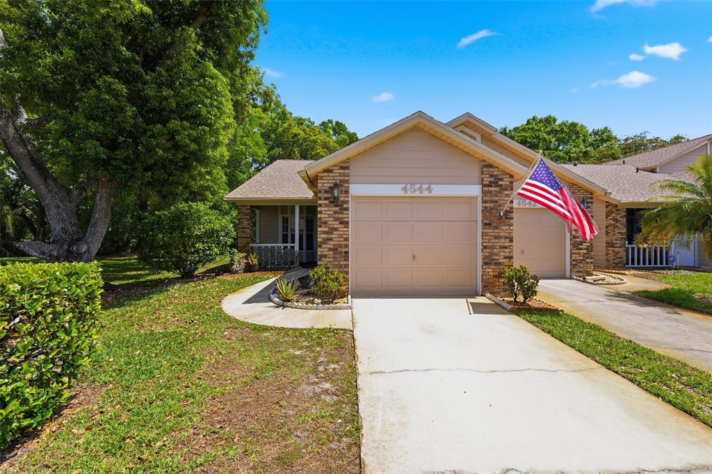 4544 Slippery Rock Road New Port Richey, FL 34653 - Photo 2 of 32 a front view of house with yard and green space