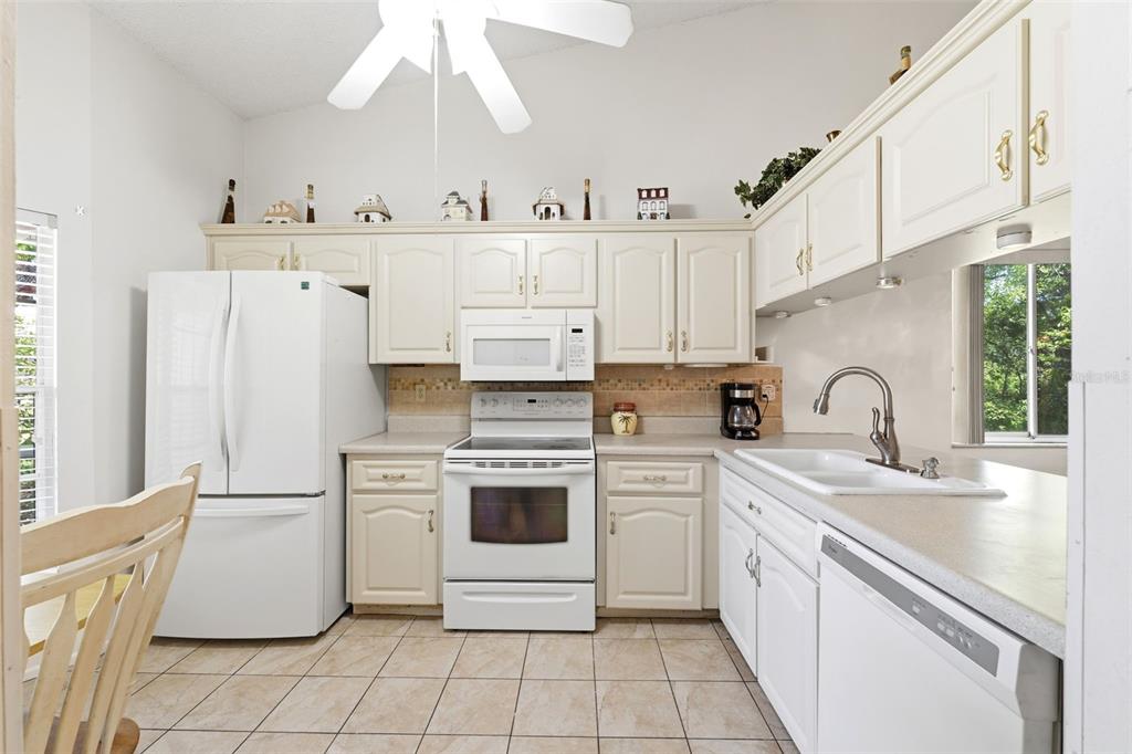 4544 Slippery Rock Road New Port Richey, FL 34653 - Photo 6 of 32 a kitchen with cabinets a sink and white stainless steel appliances