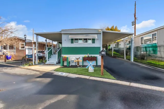 a view of a house with a yard and table