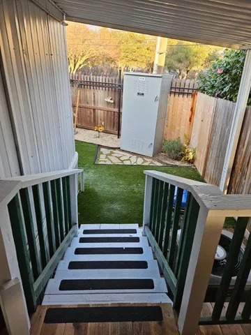 a view of balcony with wooden floor and fence