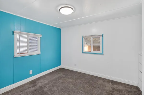 a view of a house with backyard and a patio