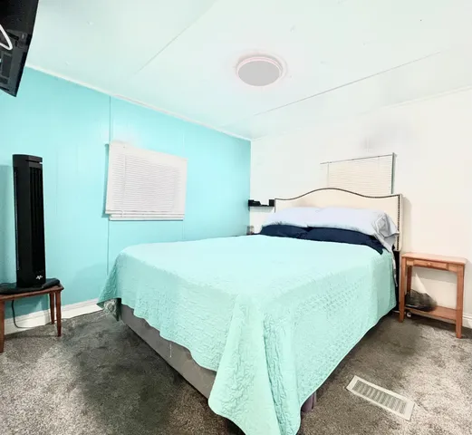 a bedroom with a bed and a chair