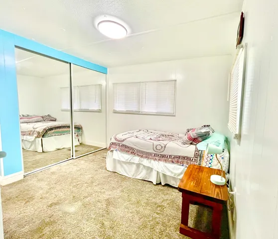 a bath room with a bed and a table