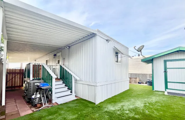 a backyard of a house with outdoor seating